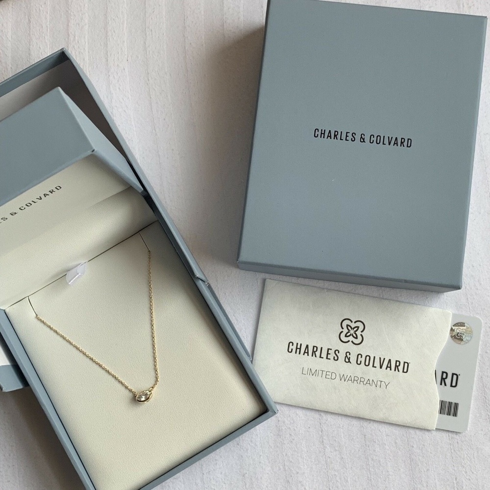 Charles & Colvard Moissanite East-West Oval Bezel